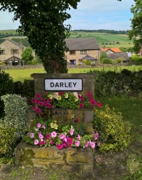 Flowers around Darley sign